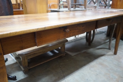 An early 19th century French rectangular fruitwood kitchen table fitted two drawers, length 201cm, depth 80cm, height 76cm